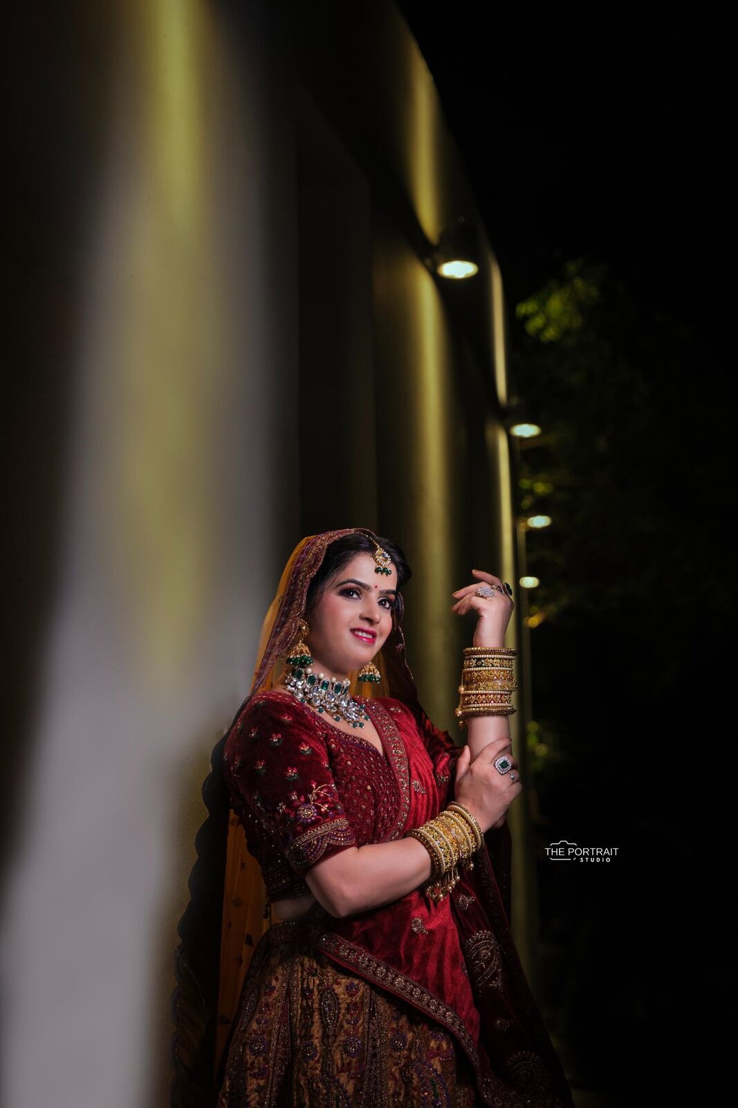 Bride in red lehenga, dramatic lighting