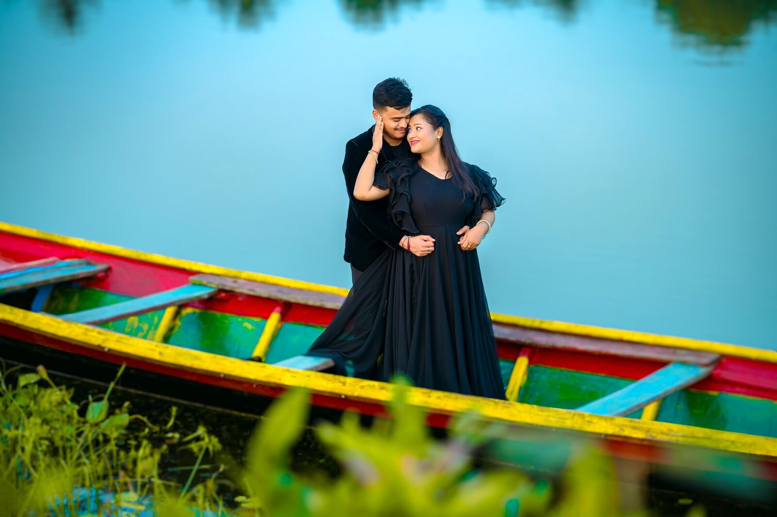 Couple in a colourful boat on a lake