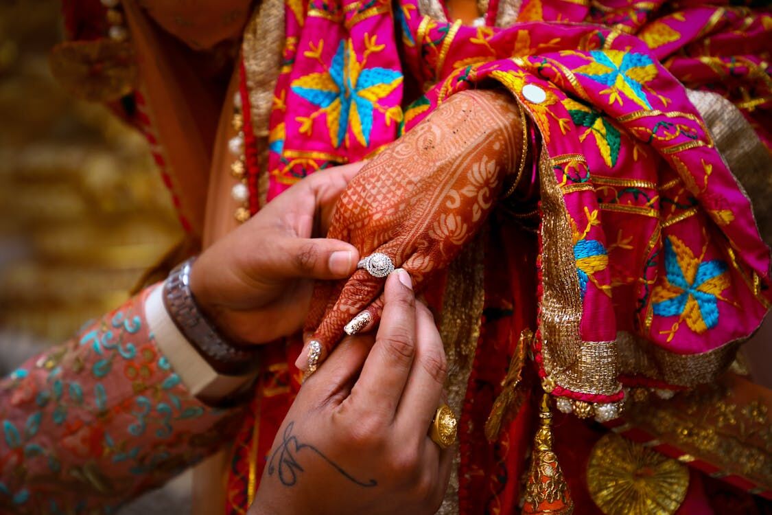 Hands with mehendi and phulkari embroidery