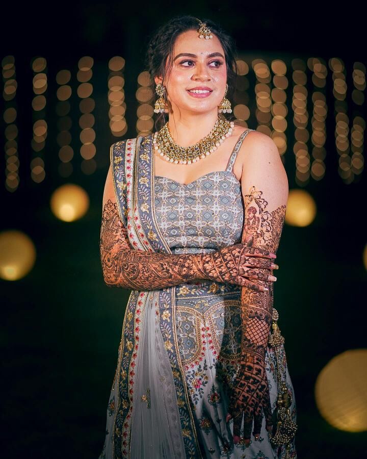 Bride with mehendi under bokeh lights