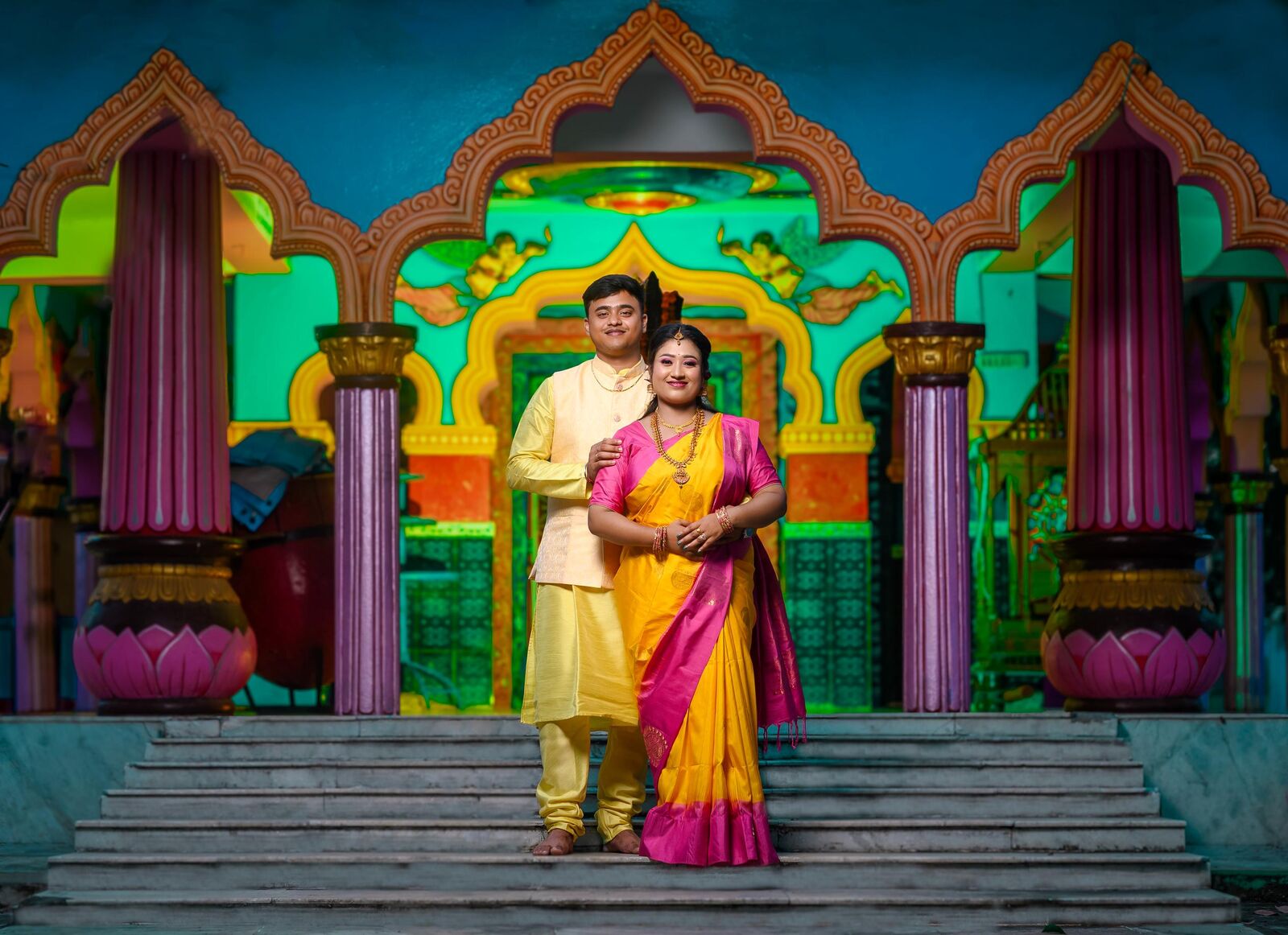 Couple in traditional attire on temple steps