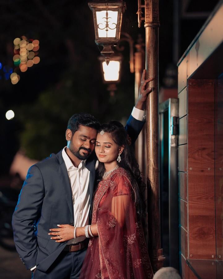 Couple beside a vintage street lantern at night
