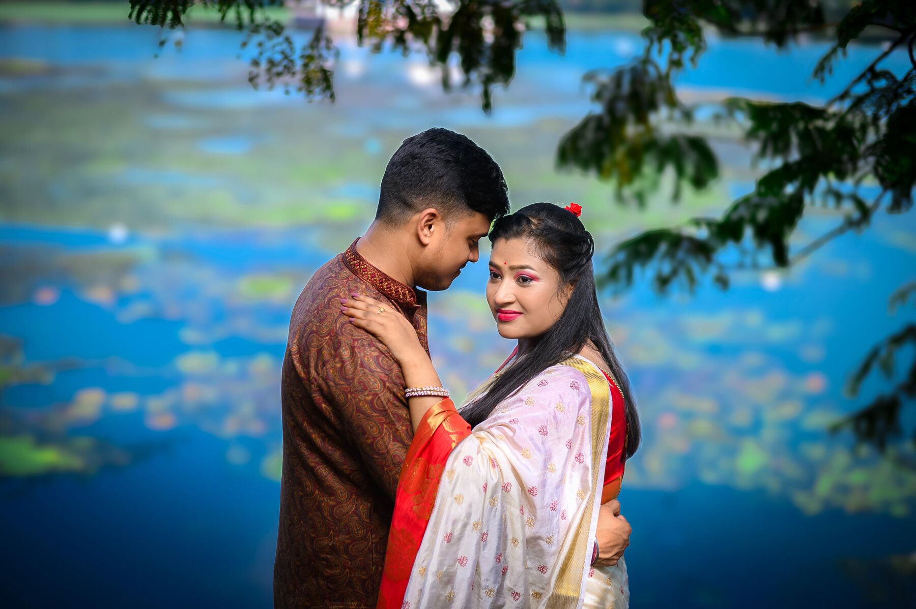 Couple embracing by a lake