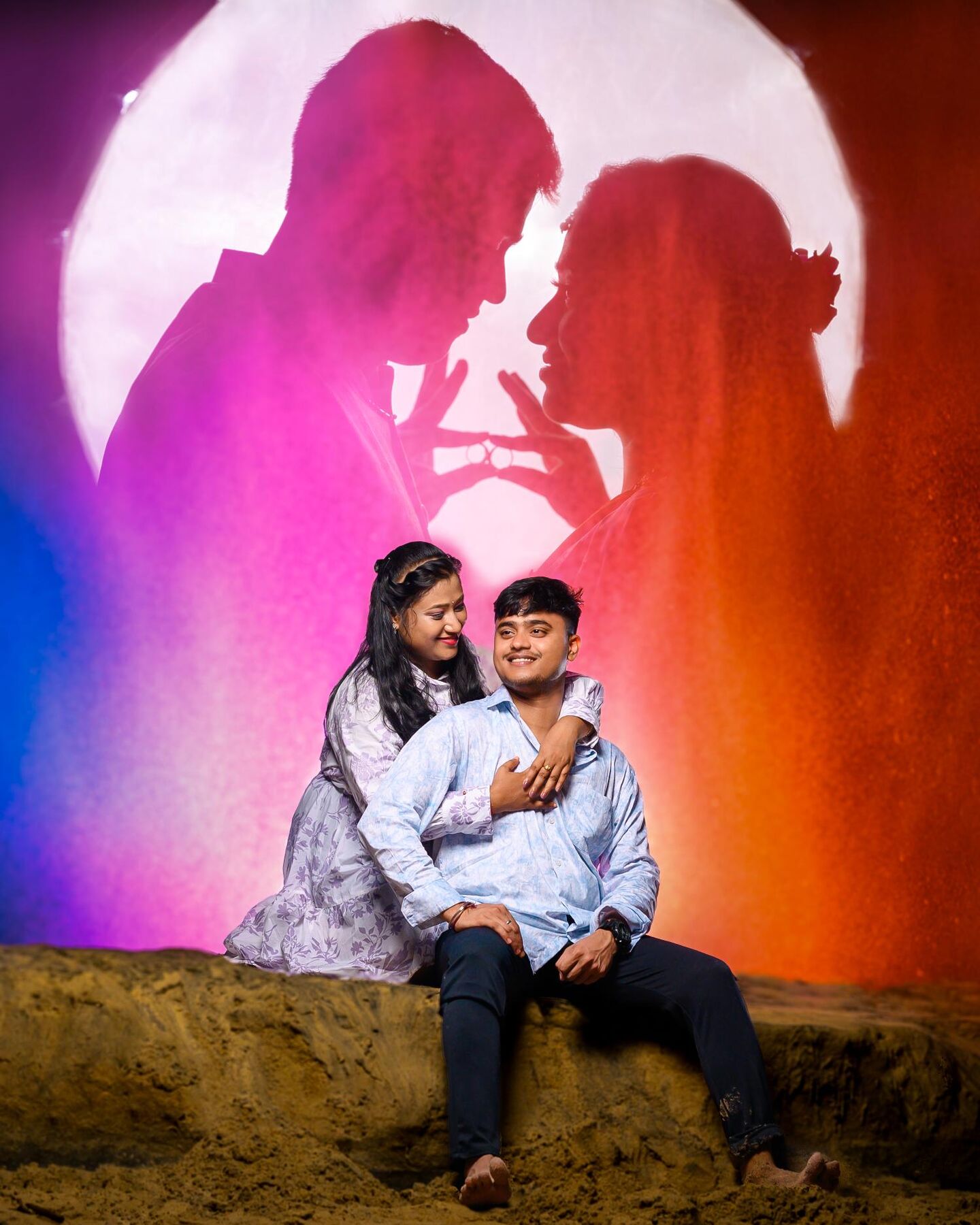 Couple posed before a silhouette backdrop